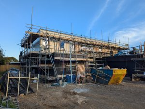 The view from the driveway entrance now the cedar and porcelain cladding has been installed to the first floor.
